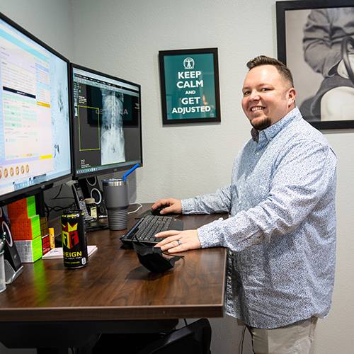 Chiropractor Tigard OR Halsy Carter at Computer Desk